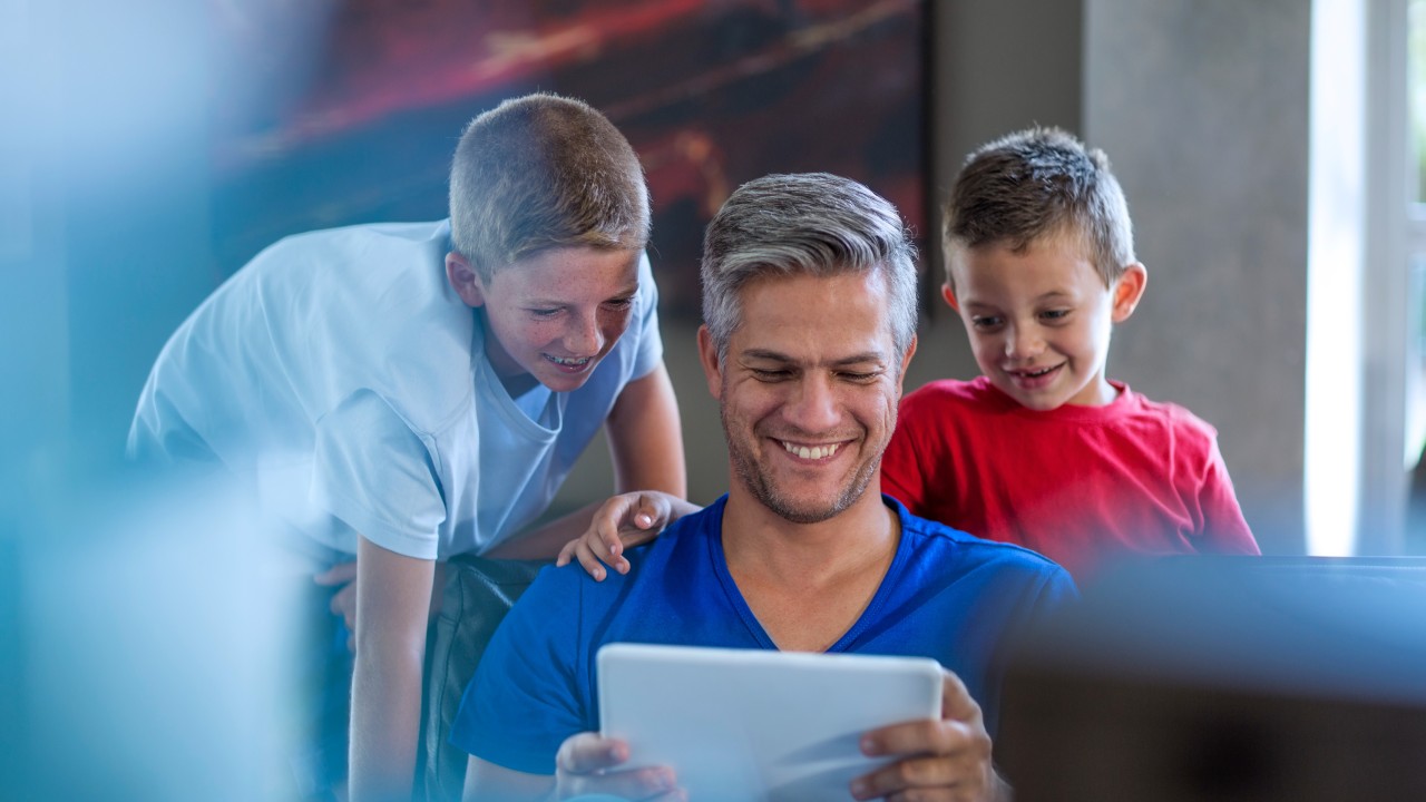 kids with parent looking at tablet