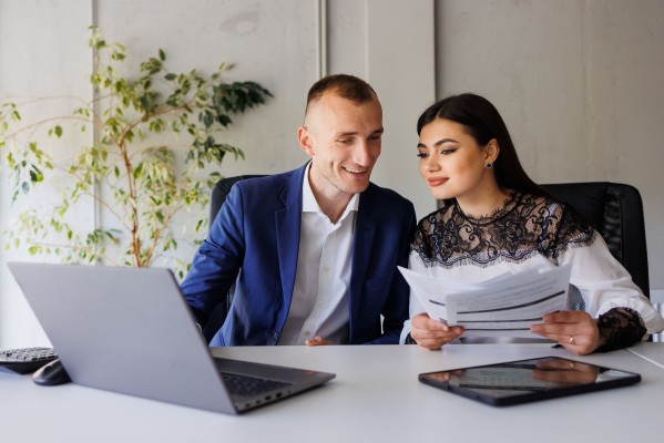 2 people work on computer