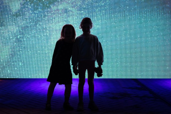 couple looking at glowing wall