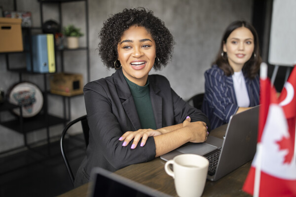 woman is happy with her computer and a cup