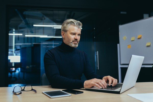 older man working on his laptop